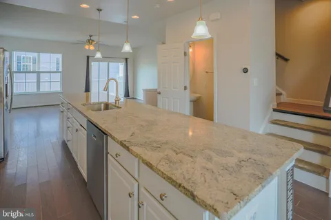 a bathroom with a granite countertop sink a large mirror and a shower