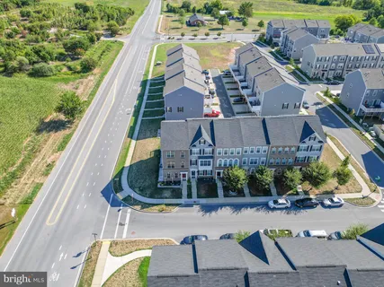 an aerial view of houses with outdoor space