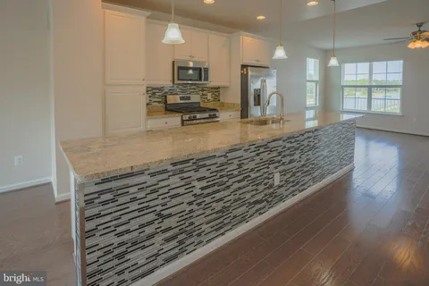 a view of kitchen with cabinets