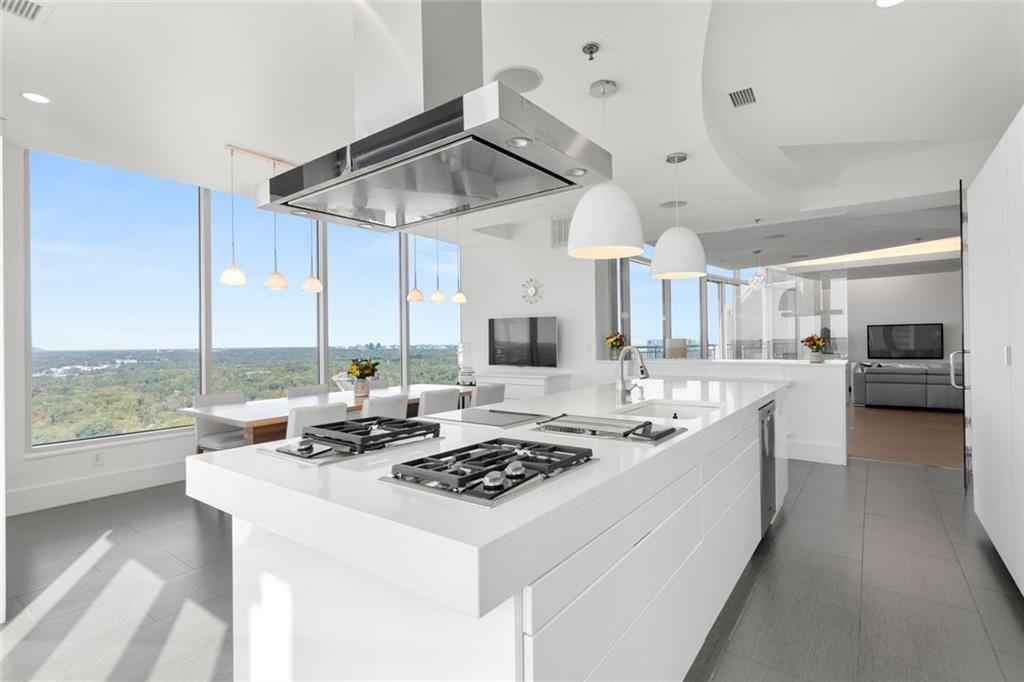 3338 Peachtree Road Northeast, Unit 3501 Atlanta, GA 30326 - Photo 17 of 46 a kitchen with kitchen island granite countertop a sink appliances and cabinets