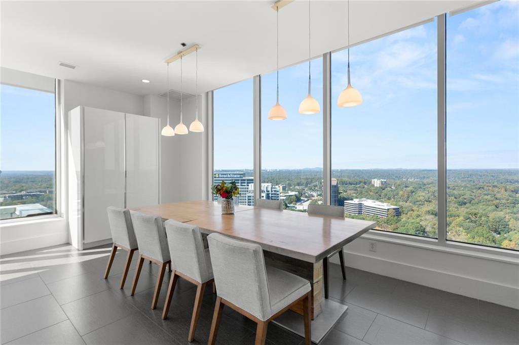 3338 Peachtree Road Northeast, Unit 3501 Atlanta, GA 30326 - Photo 19 of 46 a dining room with furniture a chandelier and wooden floor