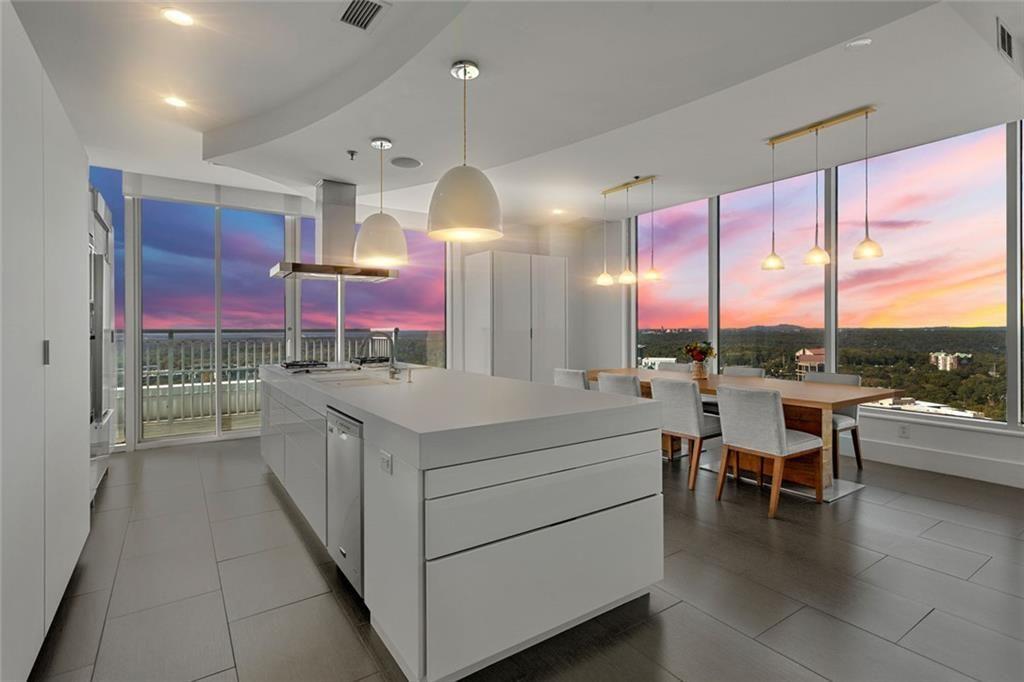 3338 Peachtree Road Northeast, Unit 3501 Atlanta, GA 30326 - Photo 2 of 46 a kitchen with a large counter top space a sink appliances and cabinets