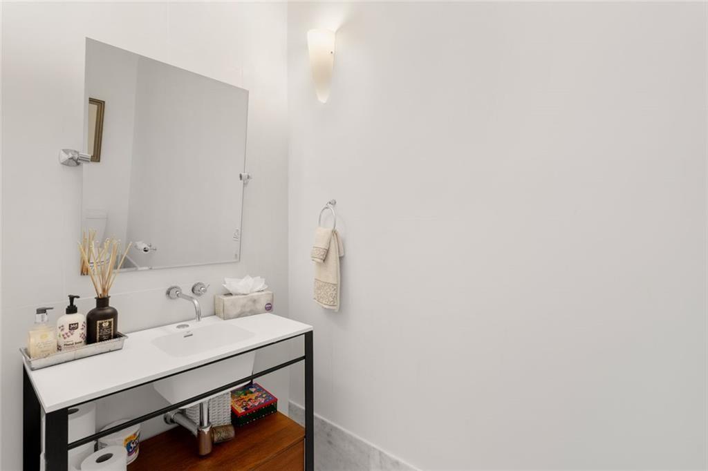 3338 Peachtree Road Northeast, Unit 3501 Atlanta, GA 30326 - Photo 24 of 46 a bathroom with a sink and a mirror