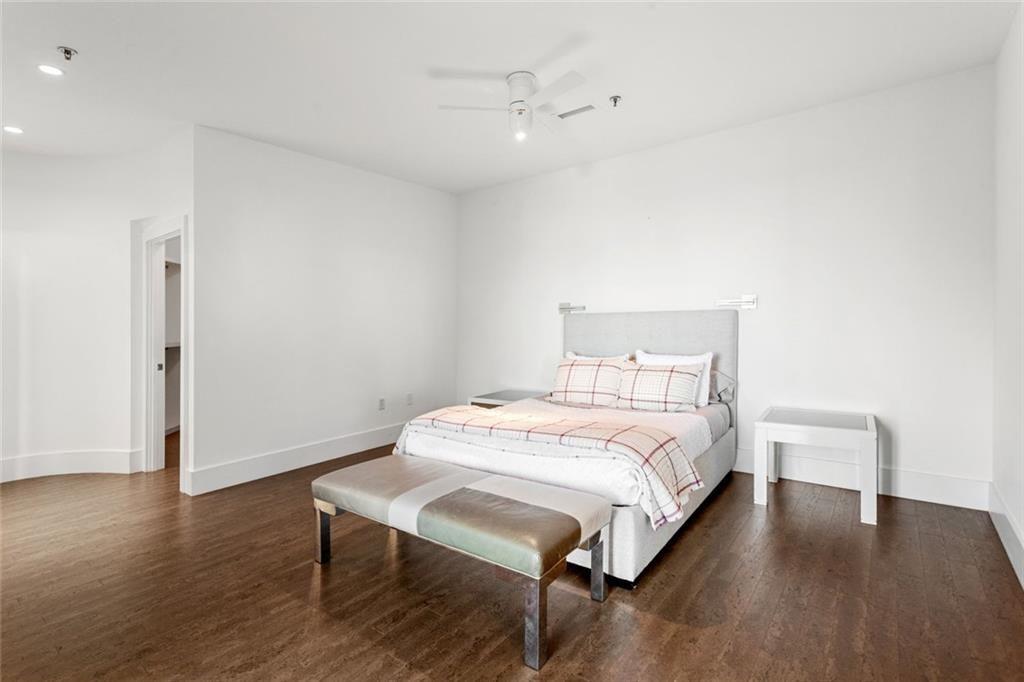 3338 Peachtree Road Northeast, Unit 3501 Atlanta, GA 30326 - Photo 25 of 46 a bedroom with a bed a table and wooden floor
