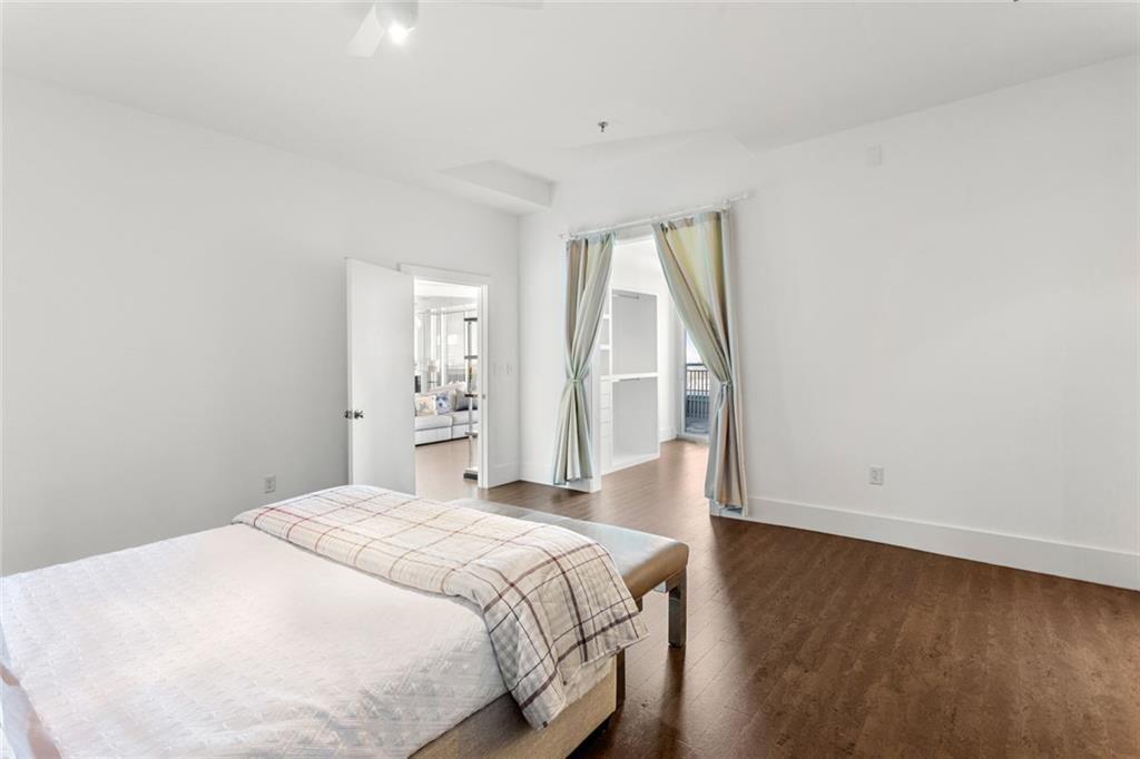 3338 Peachtree Road Northeast, Unit 3501 Atlanta, GA 30326 - Photo 26 of 46 a spacious bedroom with a bed and a window