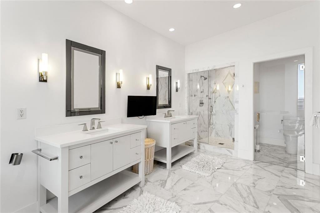 3338 Peachtree Road Northeast, Unit 3501 Atlanta, GA 30326 - Photo 29 of 46 a spacious bathroom with a double vanity sink a mirror and shower