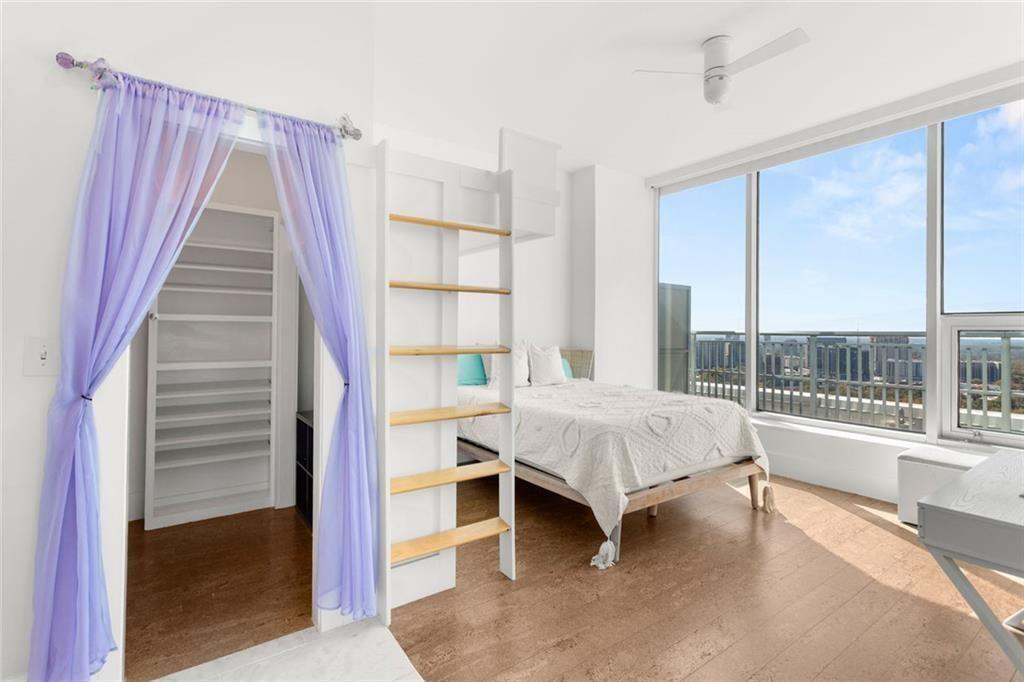 3338 Peachtree Road Northeast, Unit 3501 Atlanta, GA 30326 - Photo 32 of 46 a living room with a bed and large window