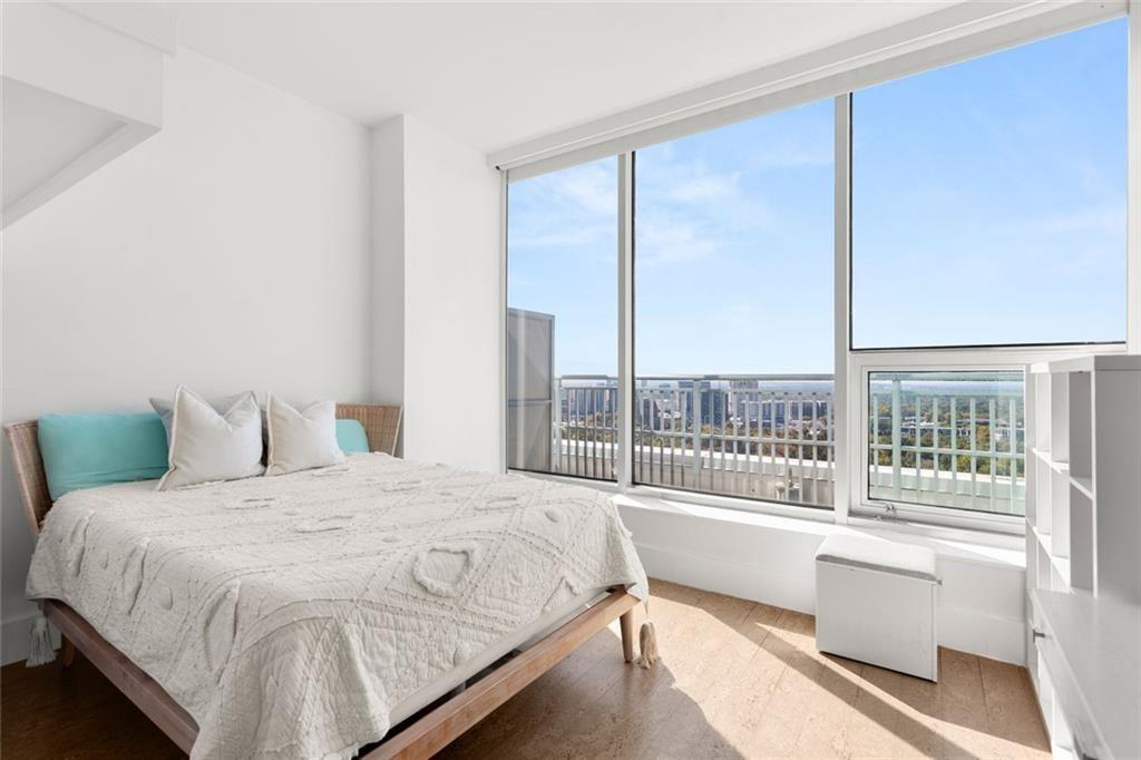 3338 Peachtree Road Northeast, Unit 3501 Atlanta, GA 30326 - Photo 33 of 46 a bedroom with a large bed and a large window