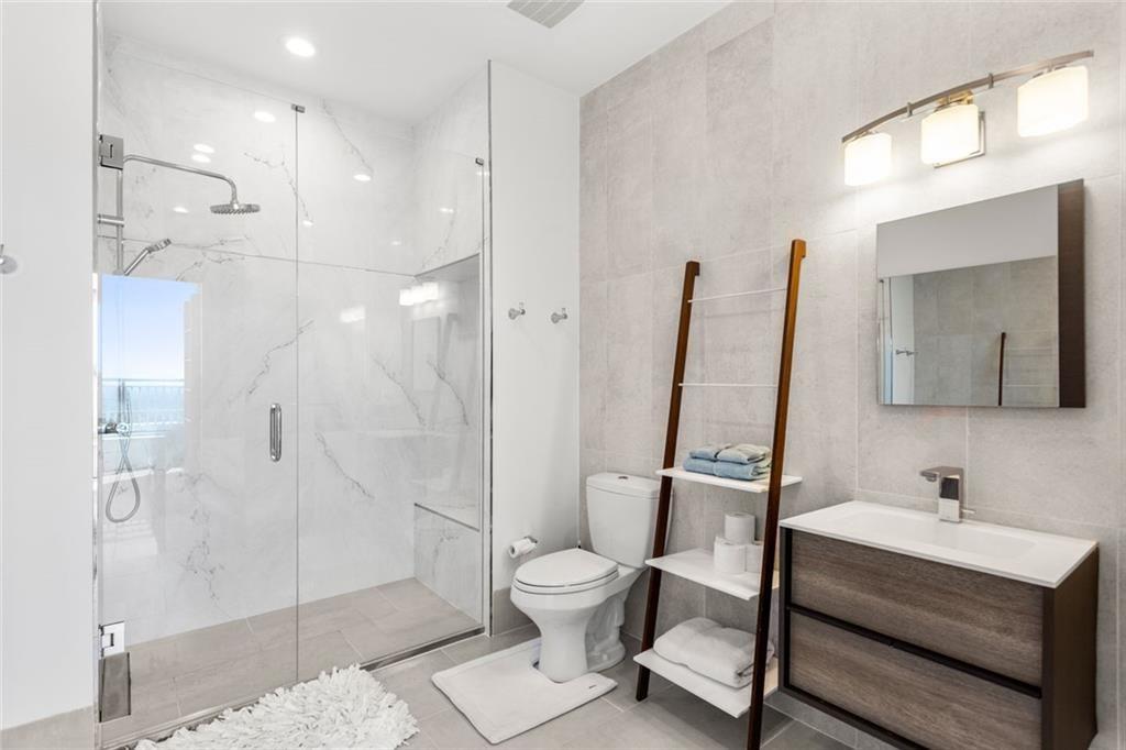 3338 Peachtree Road Northeast, Unit 3501 Atlanta, GA 30326 - Photo 35 of 46 a bathroom with a sink toilet and shower