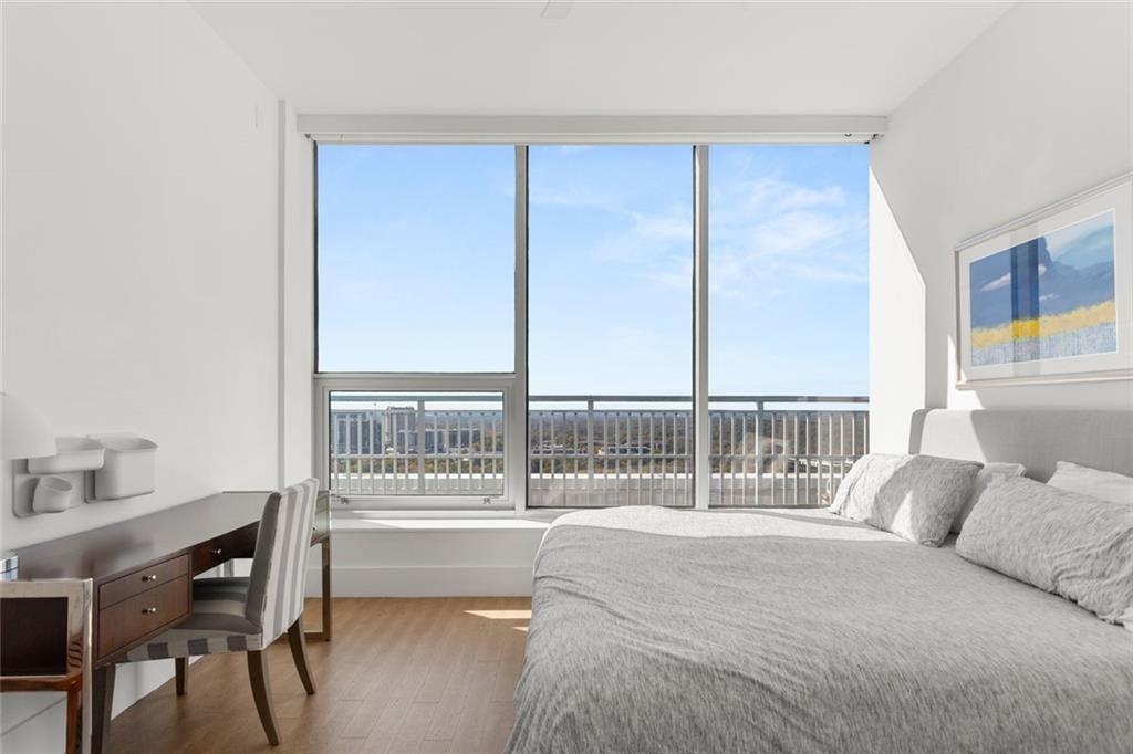 3338 Peachtree Road Northeast, Unit 3501 Atlanta, GA 30326 - Photo 36 of 46 a bedroom with a bed and a table