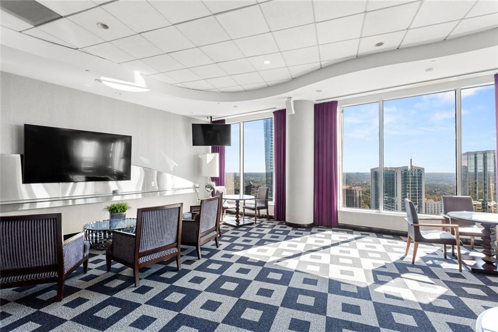 3338 Peachtree Road Northeast, Unit 3501 Atlanta, GA 30326 - Photo 44 of 46 a living room with a flat screen tv and a rug