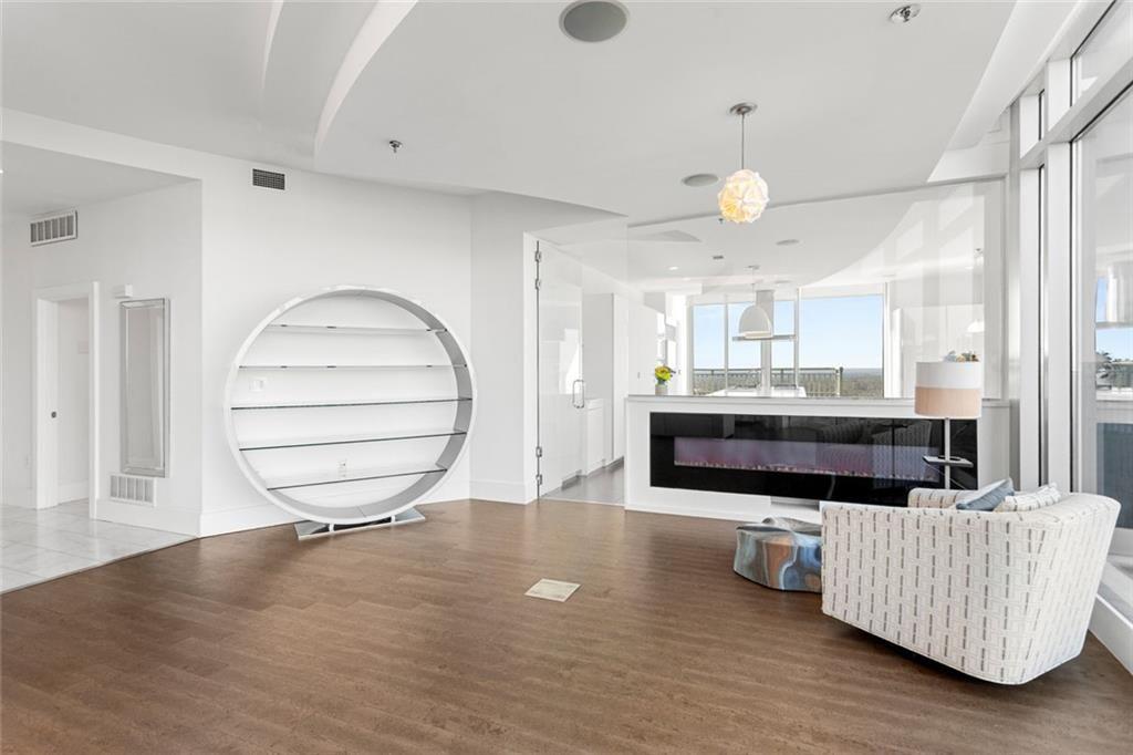 3338 Peachtree Road Northeast, Unit 3501 Atlanta, GA 30326 - Photo 7 of 46 a living room with furniture and a wooden floor