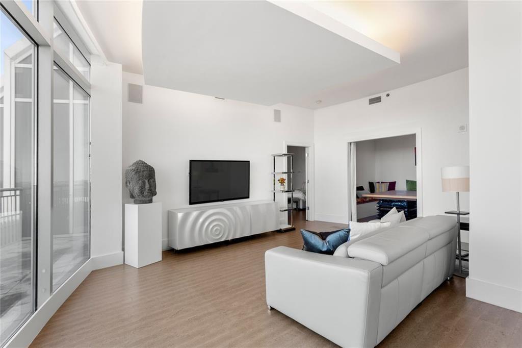 3338 Peachtree Road Northeast, Unit 3501 Atlanta, GA 30326 - Photo 8 of 46 a living room with furniture and a flat screen tv