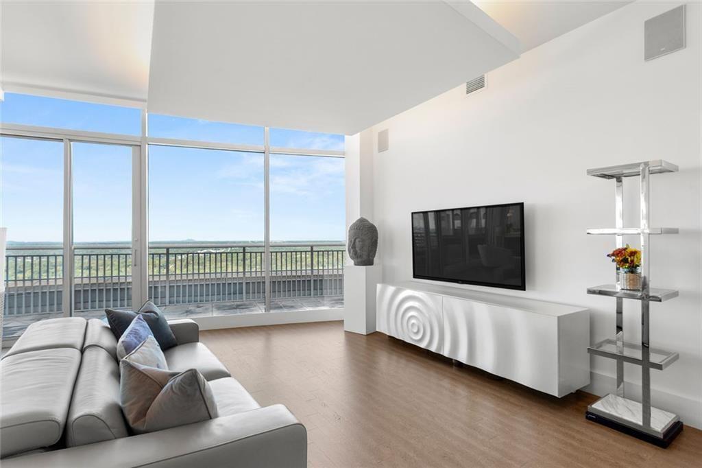 3338 Peachtree Road Northeast, Unit 3501 Atlanta, GA 30326 - Photo 9 of 46 a living room with furniture and a flat screen tv