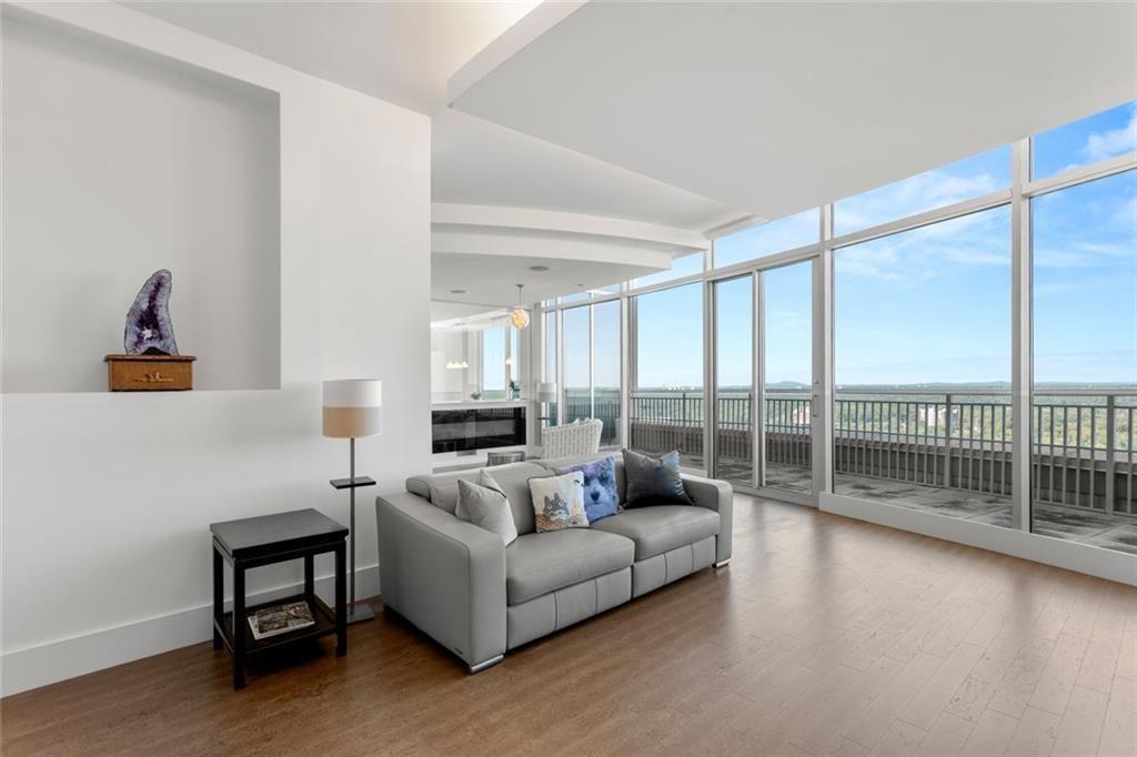 3338 Peachtree Road Northeast, Unit 3501 Atlanta, GA 30326 - Photo 10 of 46 a living room with furniture and a floor to ceiling window