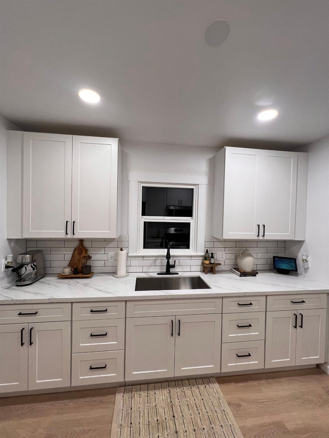 907 South 7th Street Fresno, CA 93702 - Photo 11 of 29 a kitchen with granite countertop a sink and cabinets