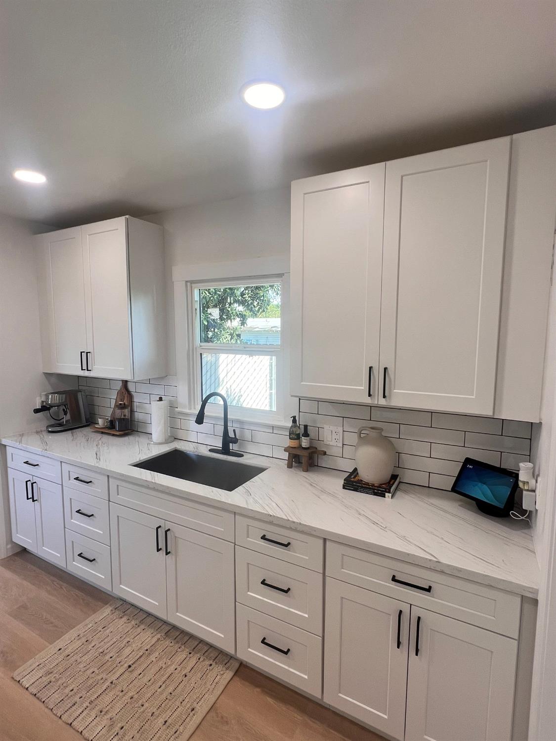 907 South 7th Street Fresno, CA 93702 - Photo 16 of 29 a kitchen with white cabinets and sink
