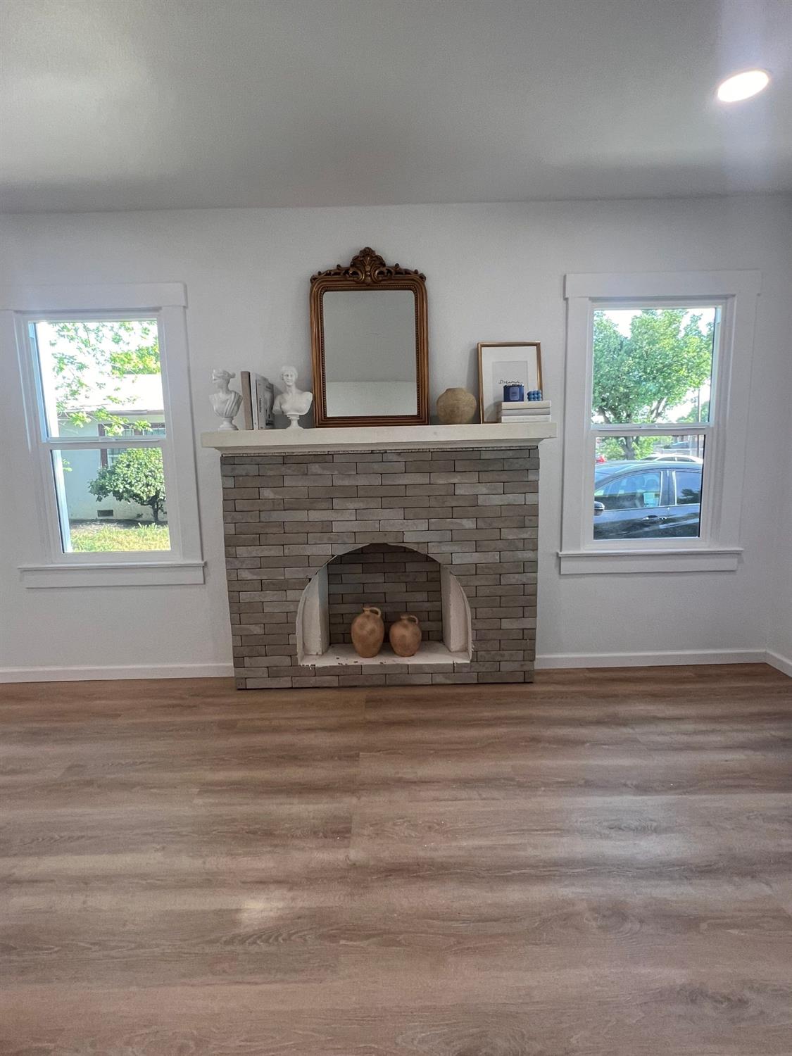 907 South 7th Street Fresno, CA 93702 - Photo 4 of 29 a view of an empty room with wooden floor fireplace and a window