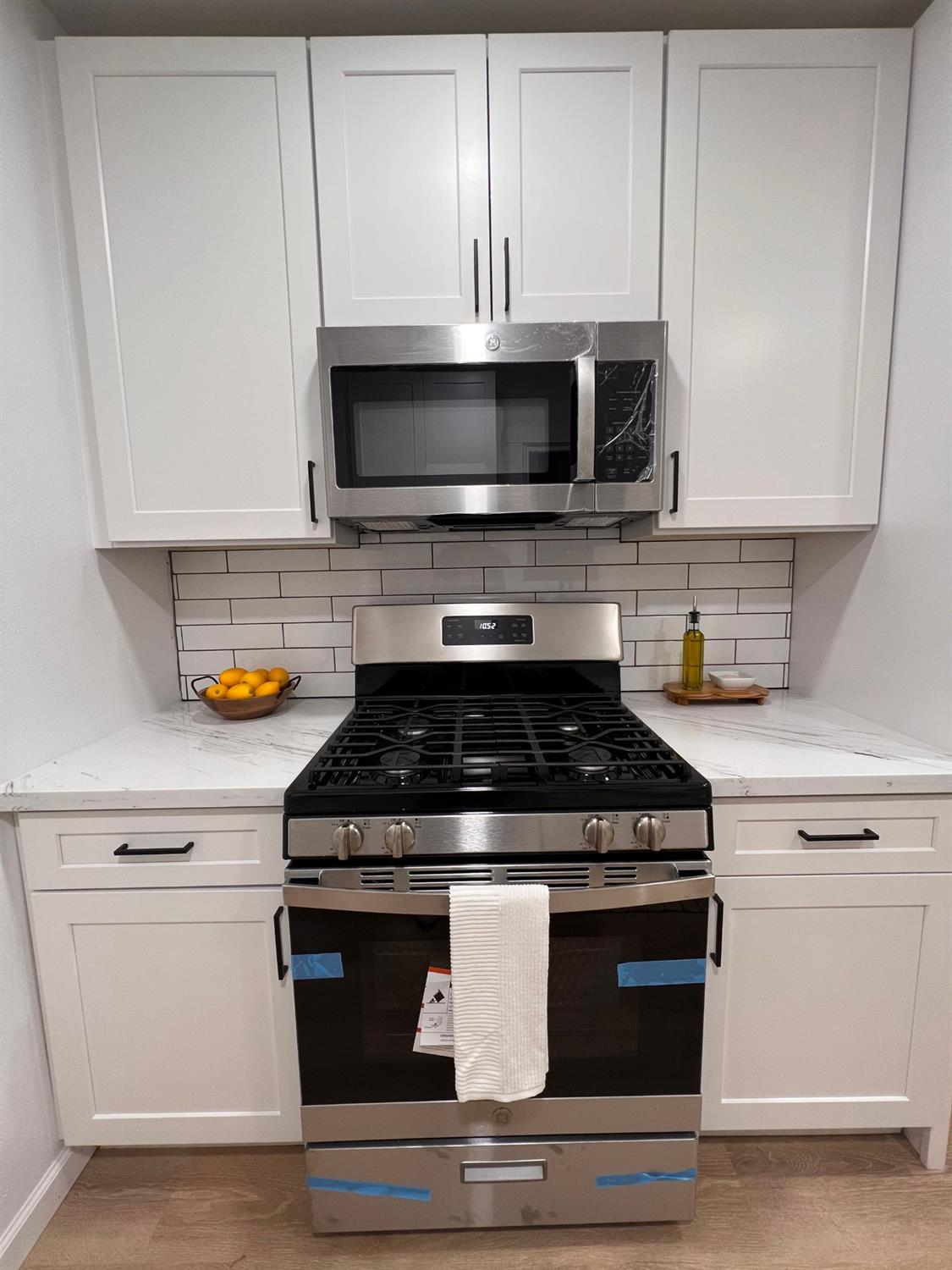 907 South 7th Street Fresno, CA 93702 - Photo 9 of 29 a stove top oven sitting inside of a kitchen