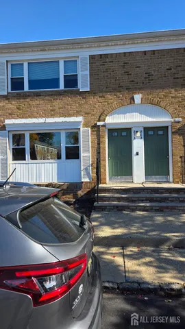 a front view of a house with parking space