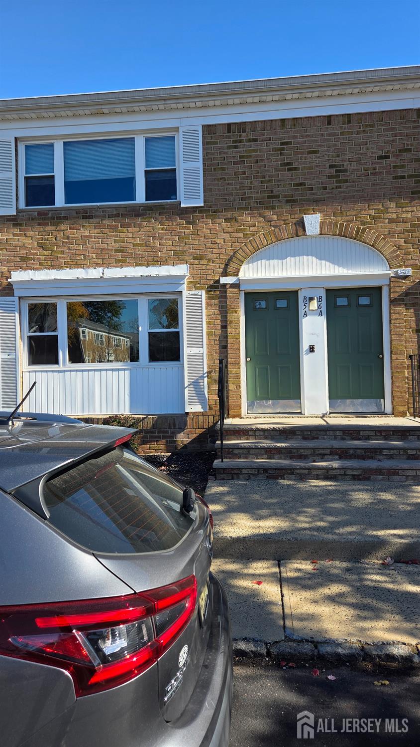 a front view of a house with parking space