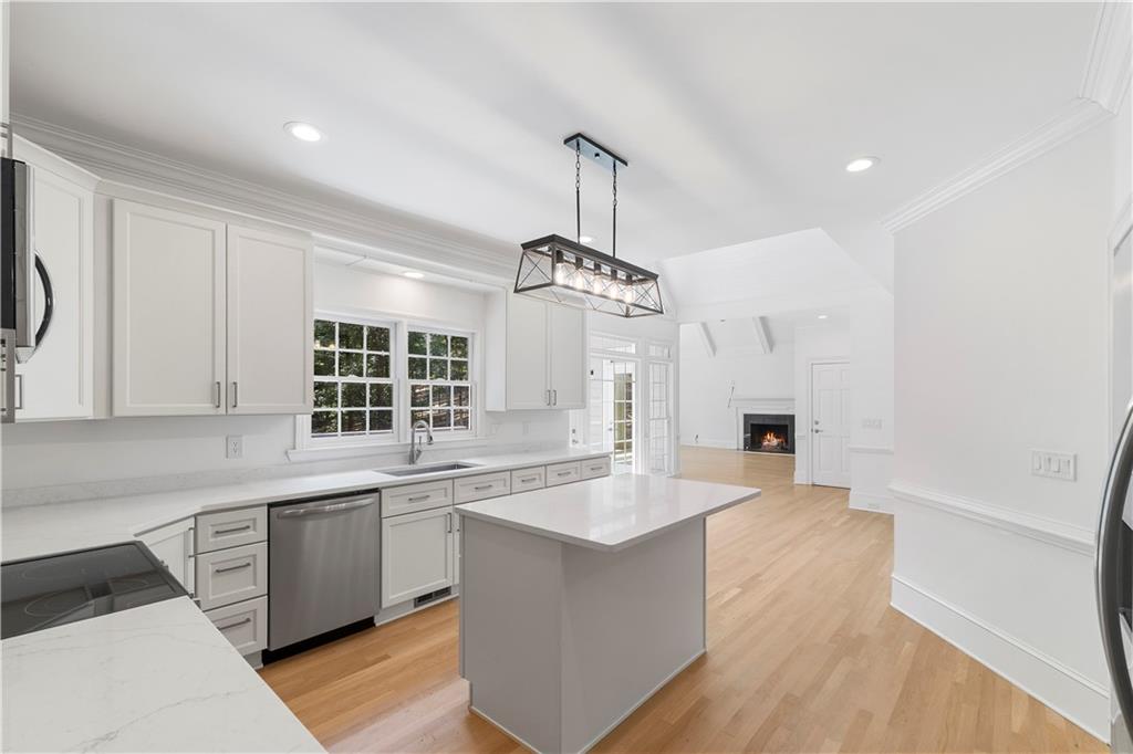 8965 Laurel Way Alpharetta, GA 30022 - Photo 13 of 79 a large kitchen with kitchen island a sink a center island stainless steel appliances and a window