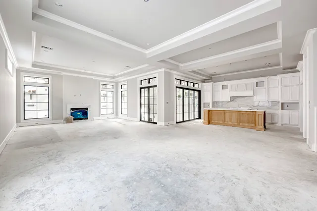 a view of an empty room with a fireplace and a window