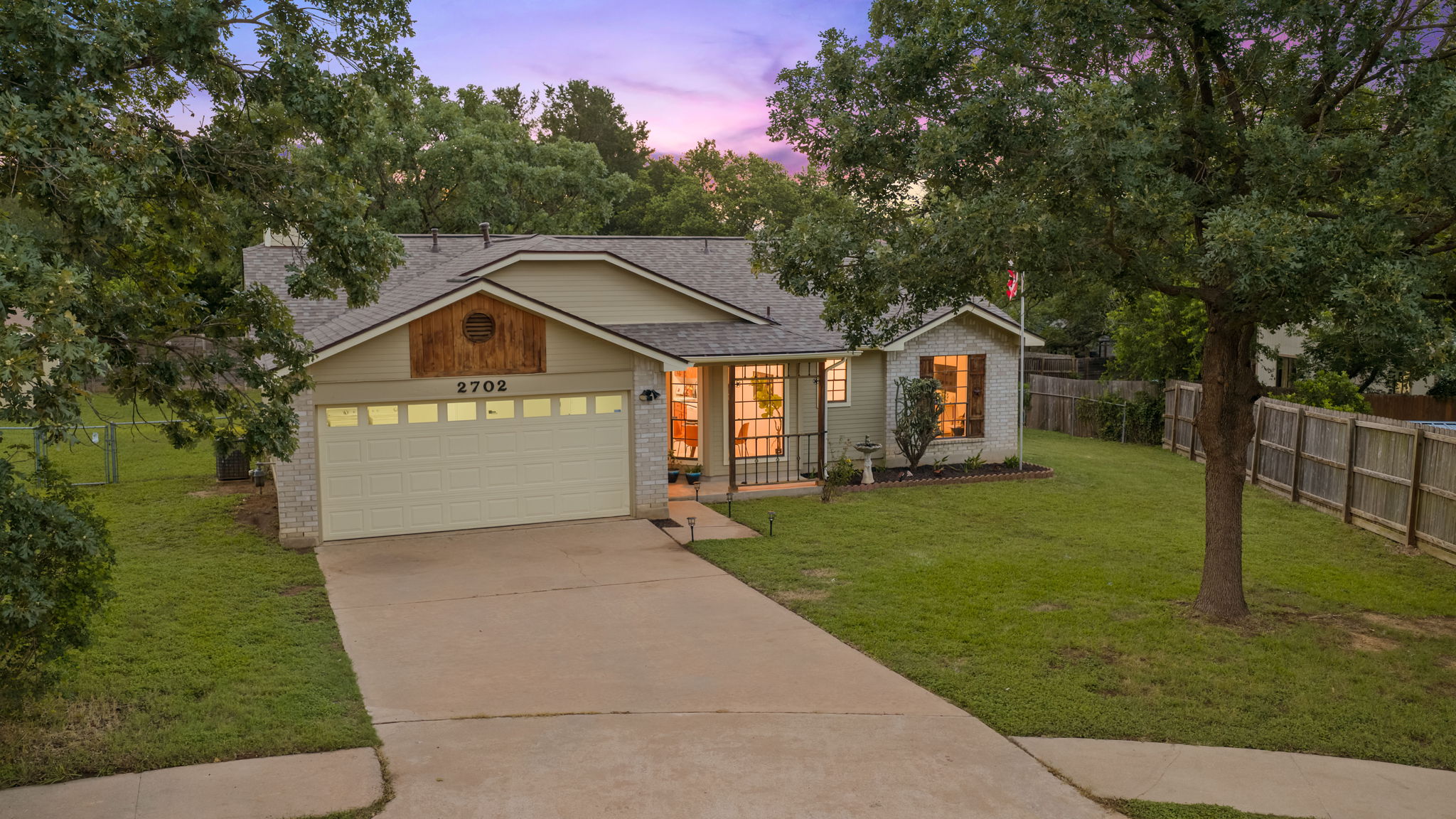 2702 Calabash Cove Austin, TX 78745 - Photo 4 of 40 a front view of a house with a yard and garage