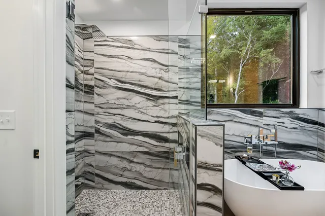 a view of empty room with wooden floor and window