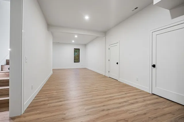 an empty room with wooden floor