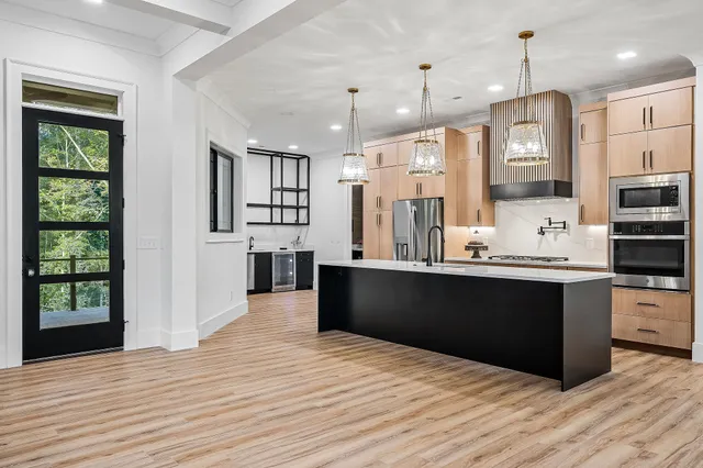a kitchen with refrigerator and cabinets