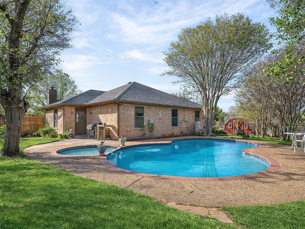 1006 Oakchase Court Azle, TX 76020 - Photo 16 of 19 a front view of a house with garden