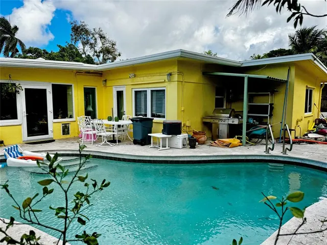 a view of a house with swimming pool patio and a garden