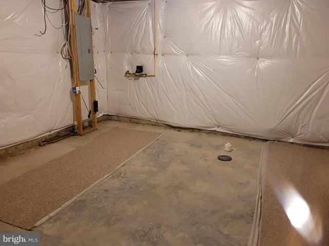 a kitchen with stainless steel appliances a table chairs refrigerator and microwave