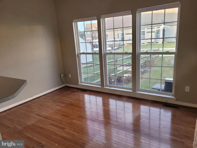 a view of a porch with wooden floor and fence