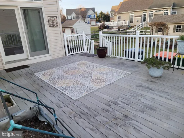 a kitchen with stainless steel appliances granite countertop a refrigerator a sink a stove and a wooden floors