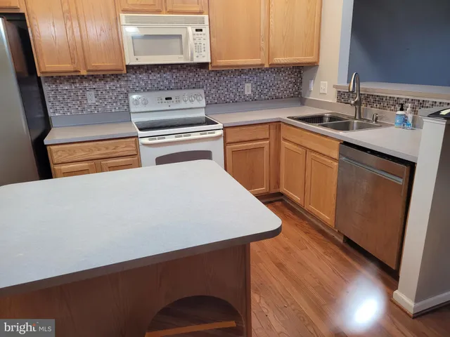 a kitchen with a sink a stove and cabinets