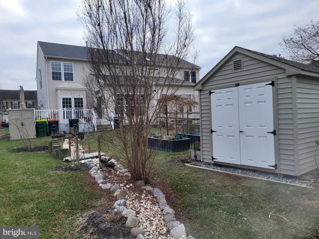 a backyard of a house with barbeque oven