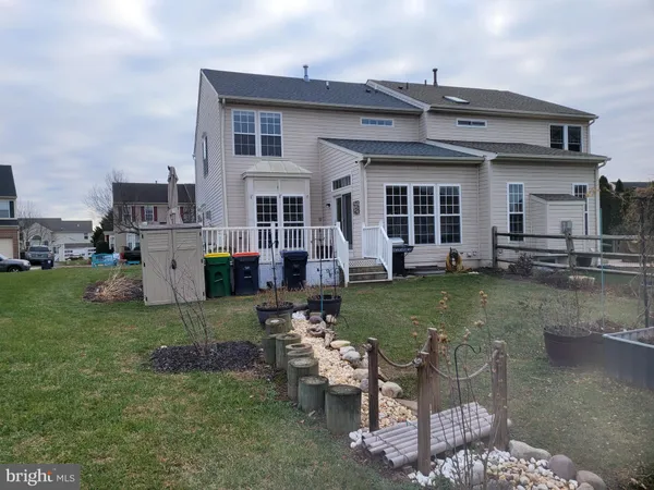 a view of a house with a yard and sitting area