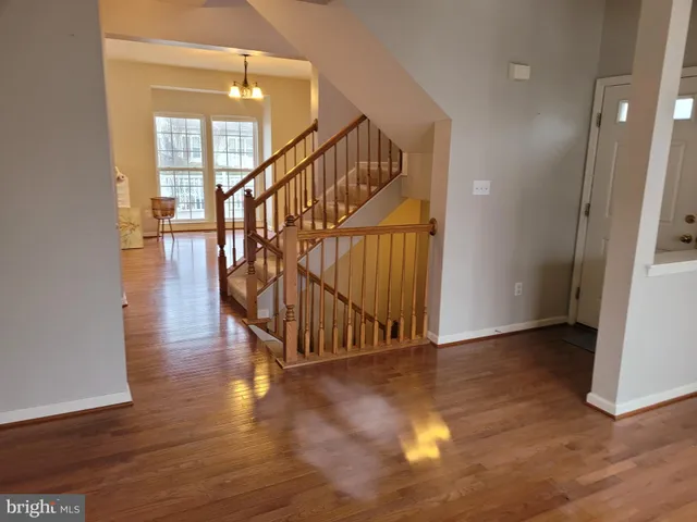 a view of an entryway with wooden floor