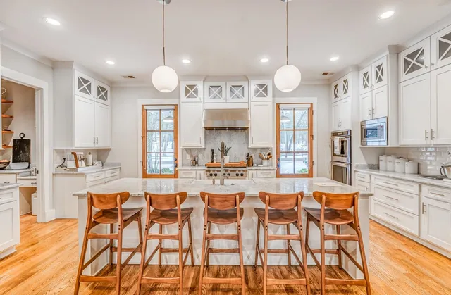 a bedroom with a bed and dresser with mirror