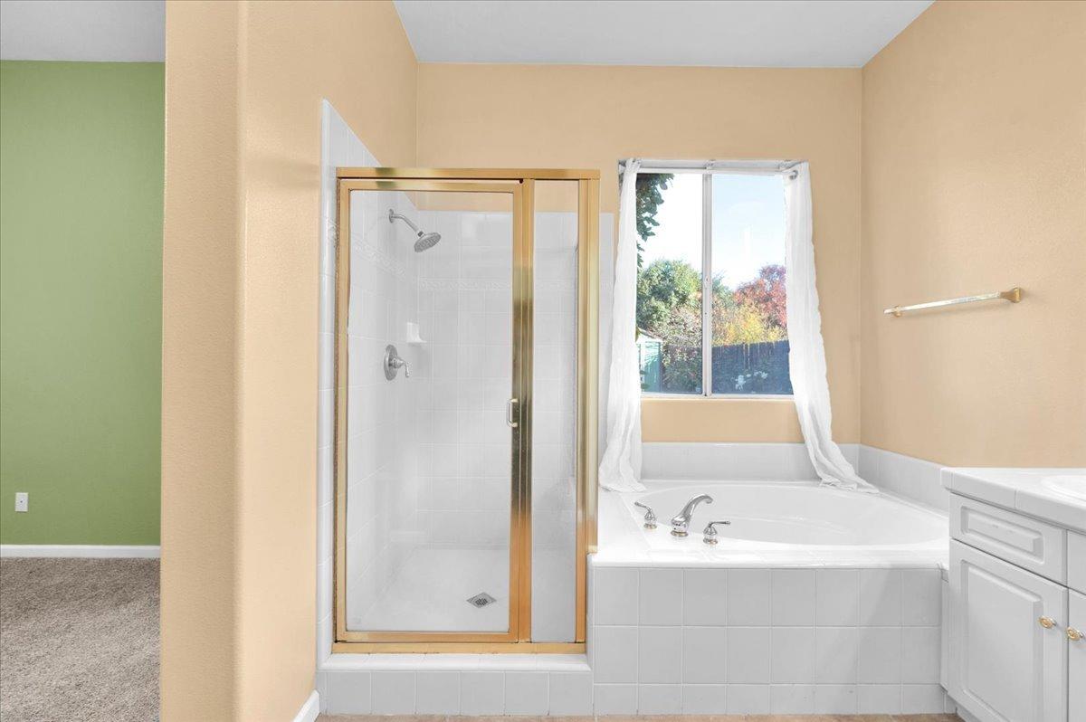 849 Megan Avenue Clovis, CA 93611 - Photo 24 of 53 a bathroom with a bathtub and a shower