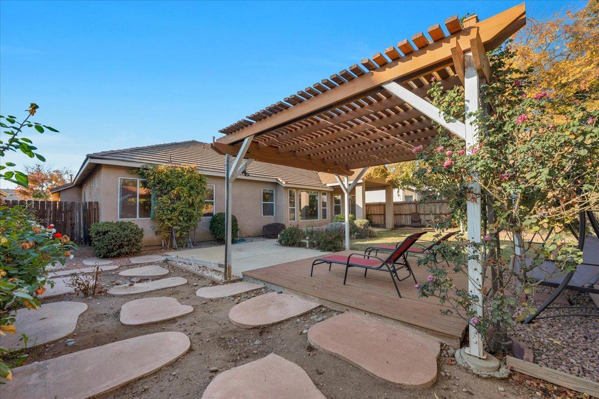 849 Megan Avenue Clovis, CA 93611 - Photo 32 of 53 a patio with a table and chairs and potted plants
