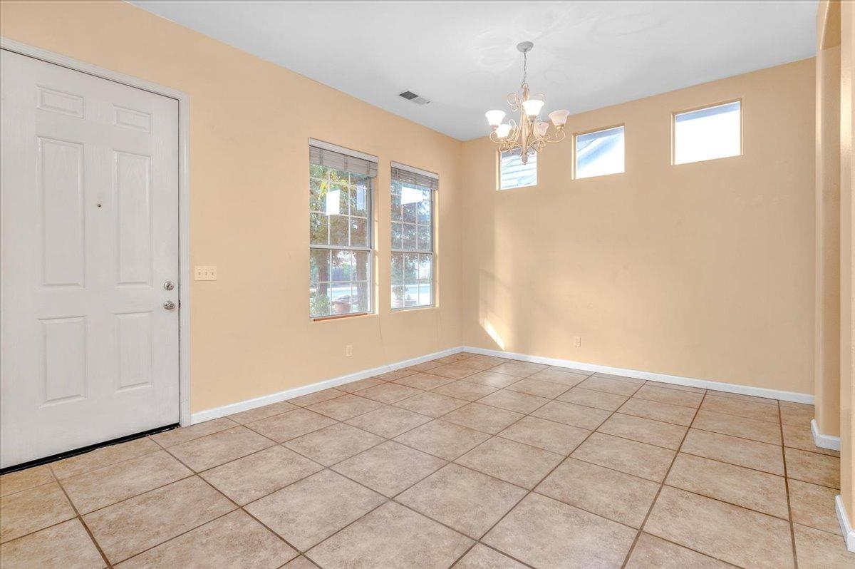 849 Megan Avenue Clovis, CA 93611 - Photo 4 of 53 a view of an empty room with window and chandelier fan