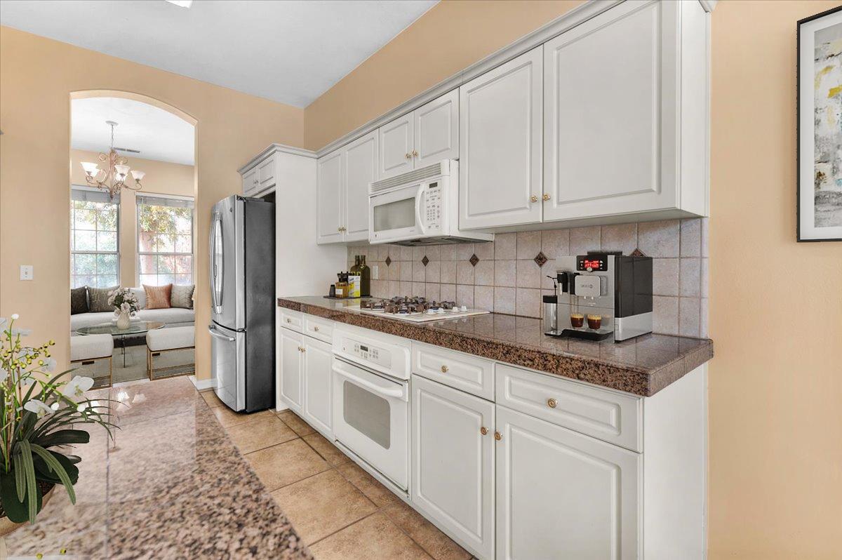849 Megan Avenue Clovis, CA 93611 - Photo 46 of 53 a kitchen with stainless steel appliances granite countertop a sink and cabinets