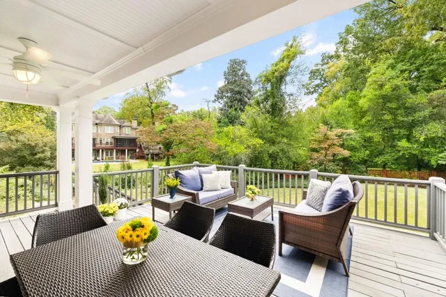 a room with lots of potted plants and wooden floor