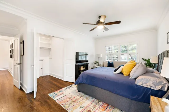 a bedroom with a bed and a television