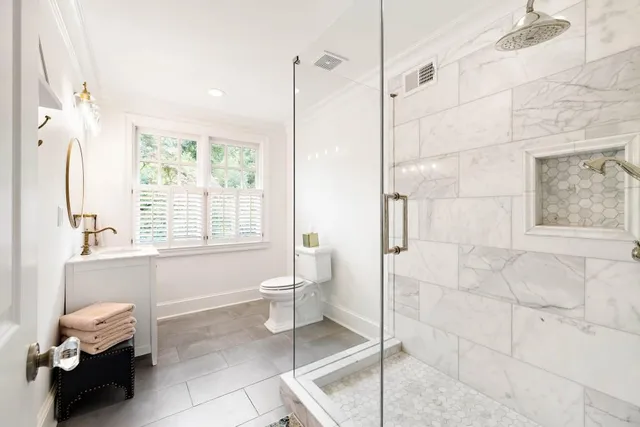 a white bath tub sitting in a bathroom next to a window