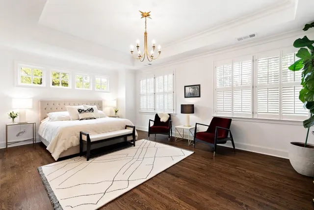 a bathroom with a sink a toilet and a large mirror