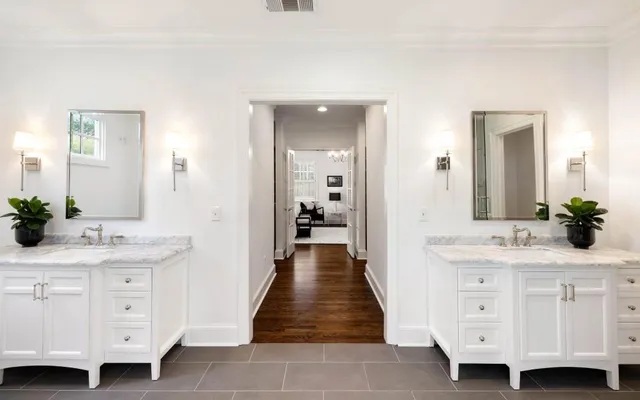 a bedroom with a bed a dresser and next to a window